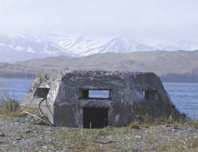 a low angled concrete building in front of the ocean