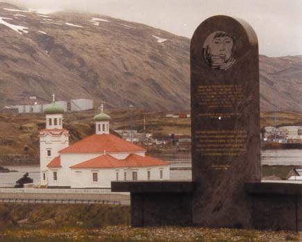 a monument in front of a town and church