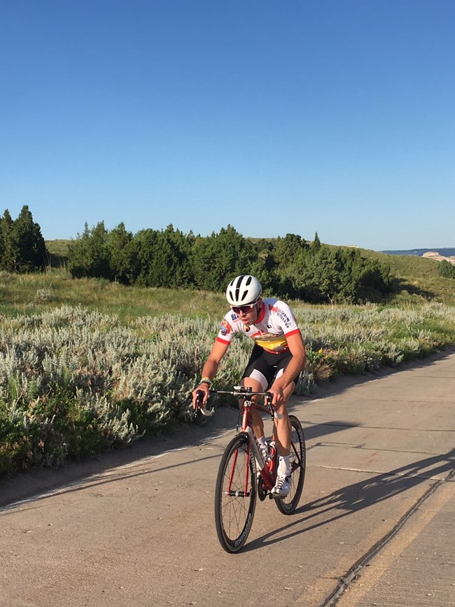 A person rides a bicycle on a closed road.