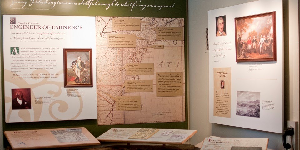 Color photo of large exhibits detailing Kosciuszko's engineering feats using large 18th-century map of the mid-Atlantic colonies.