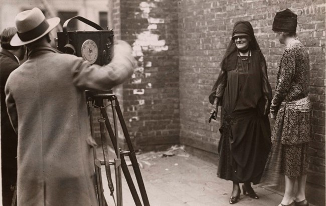 Sepia image of Mrs. Roosevelt and another lady being filmed.