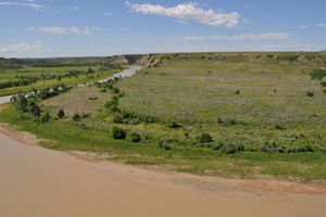 A view across the river to a floodplain and a plateau