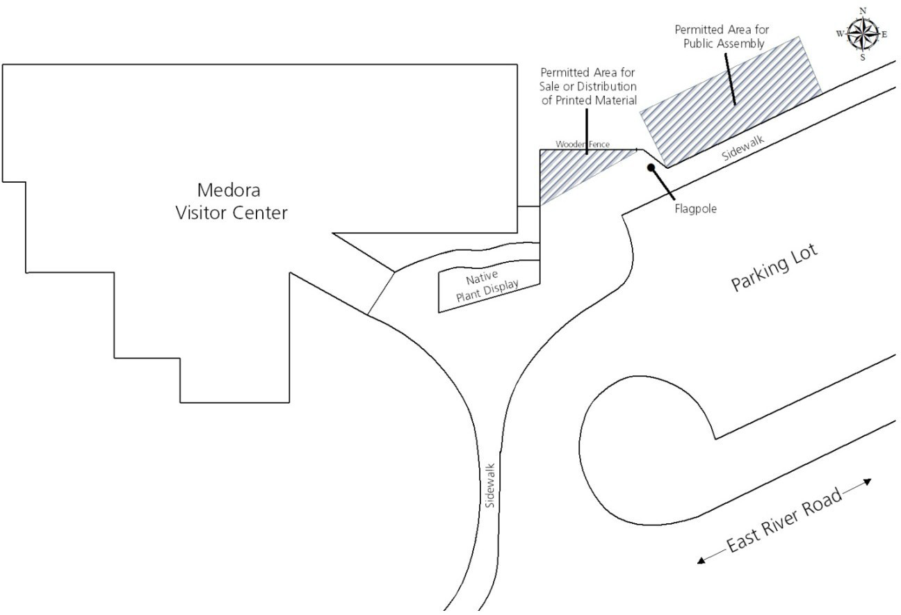 A map showing the South Unit Visitor Center area and designated location for printed materials and permitted area for public assembly. Both areas are just west of the visitor center and north of the parking lot.