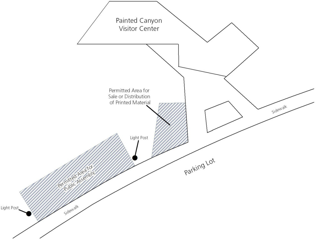A map showing the Painted Canyon Visitor Center area and designated location for printed materials and permitted area for public assembly. Both areas are to the bottom left of the visitor center along a sidewalk.
