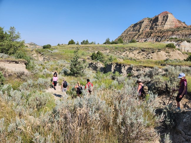 A group of hikers are led on a ranger-guided hike through the North Dakota badlands.