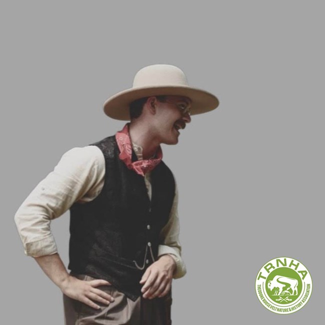 A photo of a young Theodore Roosevelt reenactor on a grey background. The Theodore Roosevelt Nature and History Association logo is in the bottom right corner.