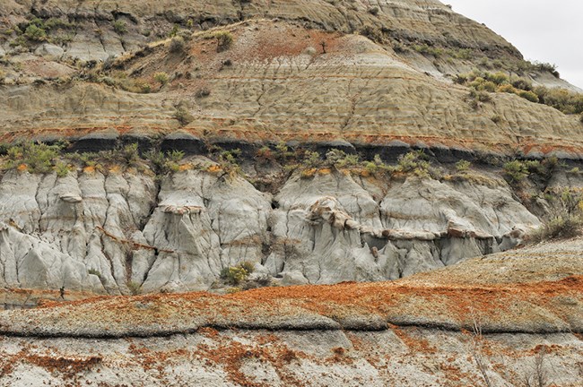 colorful horizontal layers of rock on a hillside