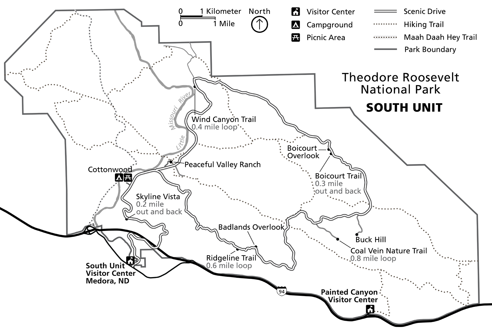 A line drawing map showing the South Unit's boundary, a scenic loop drive, and numerous trails and overlooks