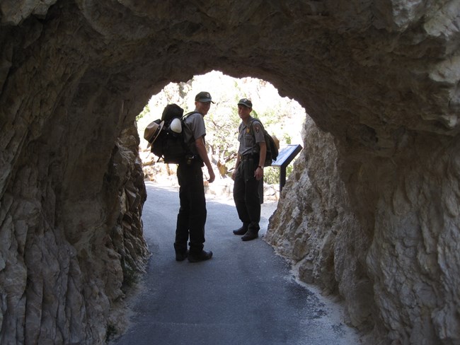 People-rangers at tunnel on trail People-rangers at tunnel on trail