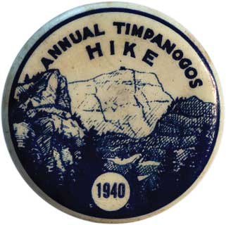Blue and cream colored lapel pin from the 1940 Annual Mount Timpanogos Hike featuring a graphic of Mount Timpanogos.