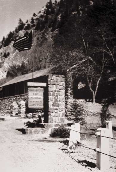 Black and white view of the historical visitor center featuring stacked rock walls and an entrace sign column.