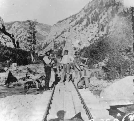 Black and white of photo of several men and a horse, centered on the tracks of the American Fork Canyon Railway in the 1870s. Black and white of photo of several men and a horse, centered on the tracks of the American Fork Canyon Railway in the 1870s.