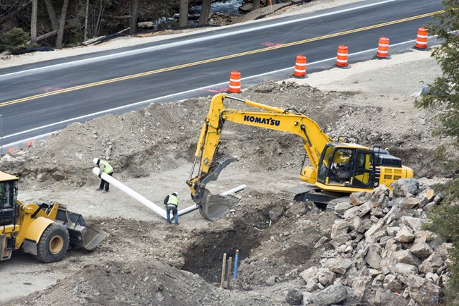 Construction equipment digs hole for new visitor center foundation Construction equipment digs hole for new VC foundation