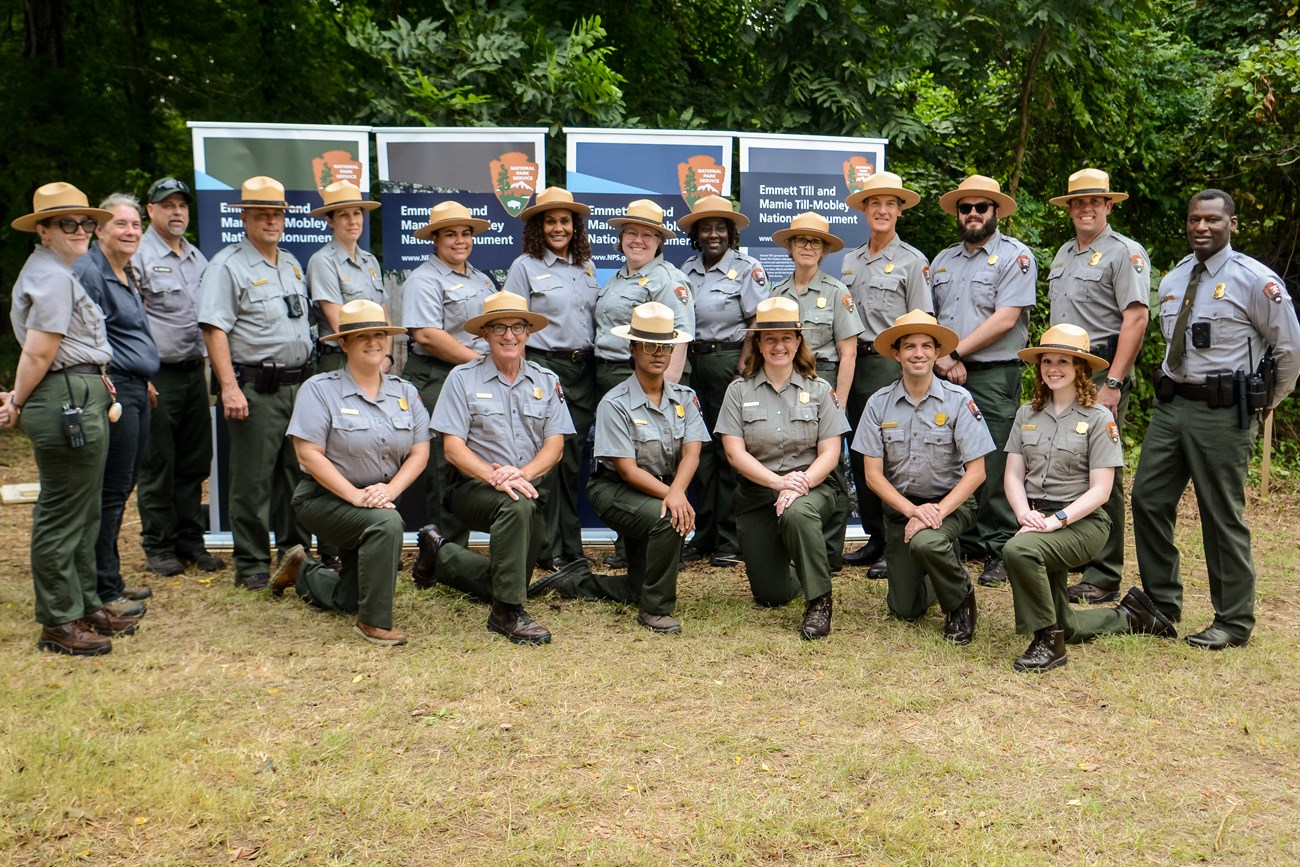 Rangers stand in a line, with several others kneeling in front of them