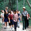  School group walking up a trail with a ranger.