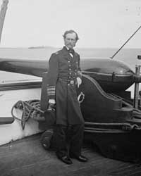civil war era photo of a dahlgren cannon on ship deck with uniformed man in front leaning on the cannon