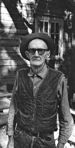 Willie Browne in front of his cabin