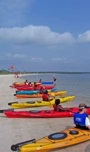 Timucuan Explorers in their kayaks on the beach Timucuan Explorers in their kayaks on the beach