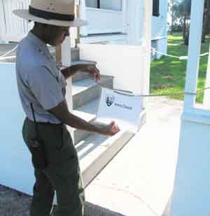 Ranger putting up a sign