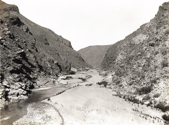 Black and white image of the Salt River Canyon before the dam. Canyon with a small river running through the left side.