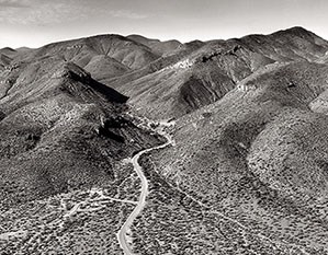 Black and white image of road leading in to Tonto National Monument from above.
