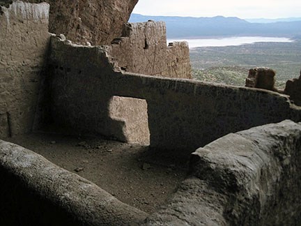 Upper Cliff Dwelling Room 17. Four walls and no ceiling create an open room. A half T shaped door it shown on the far wall. The room overlooks the Tonto Basin and Roosevelt Lake.