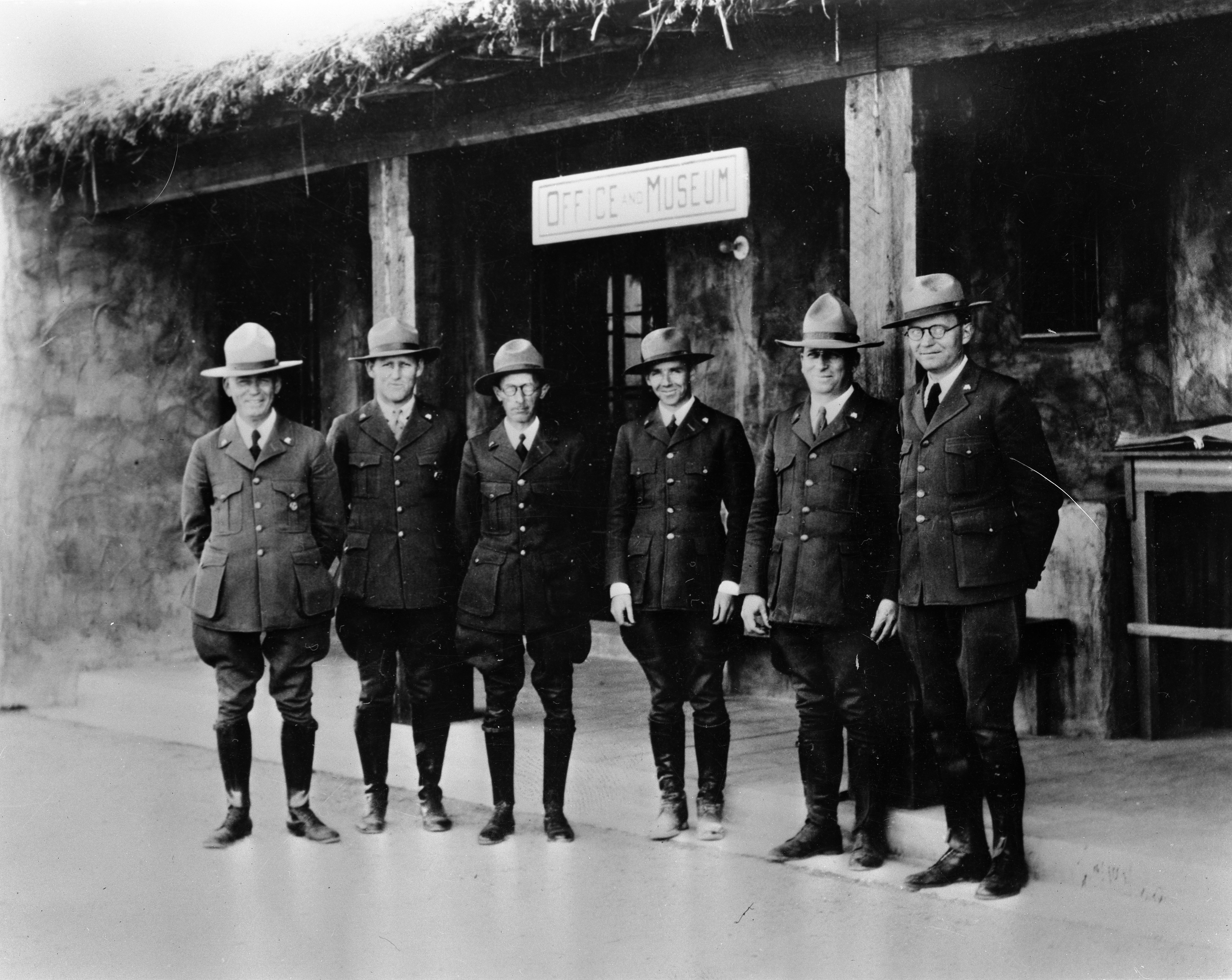 Pinkley and Crew at Casa Grande Ruins A black and white photo of Pinkley and group of park rangers in front of Casa Grande Visitor Center