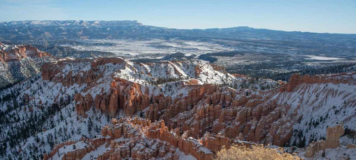 1-3 hour winter banner An amphitheater of red rock formations covered in snow.