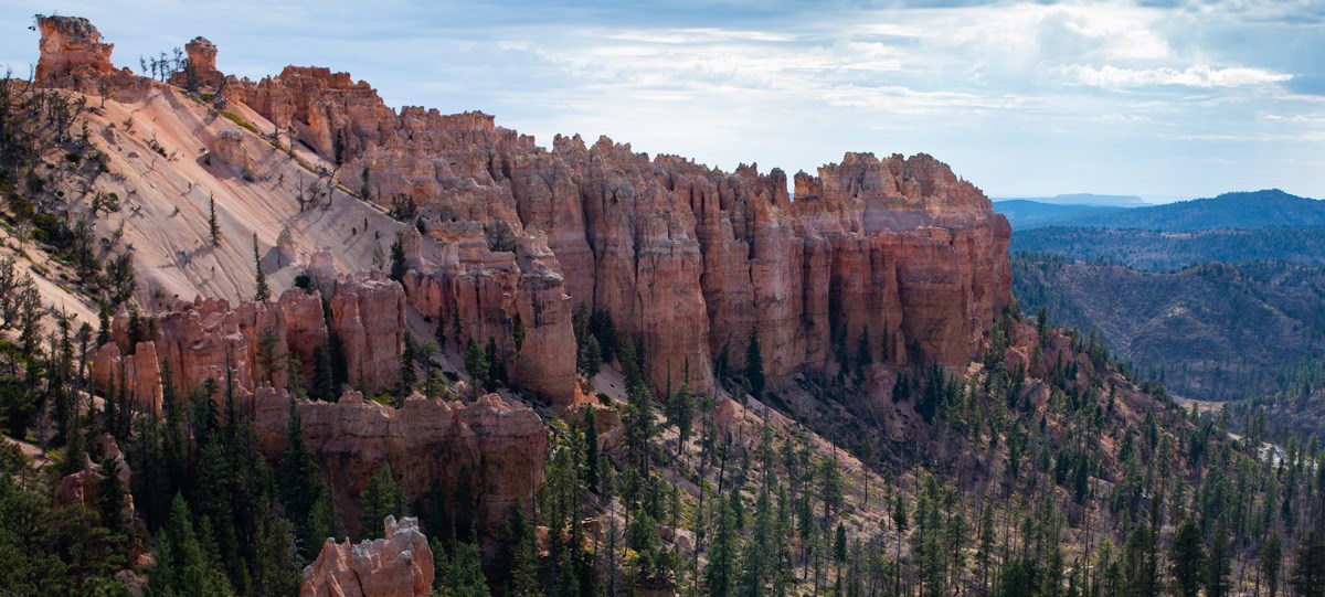 4+ hour summer banner Spiky, jagged red rock formations from above.