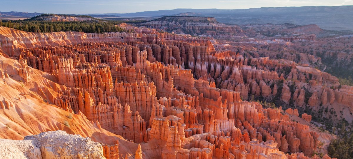 The sunrises over an amphitheater of red rock formations.