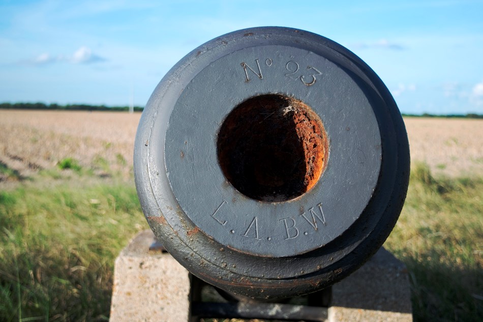 View down barrel of iron cannon View down barrel of iron cannon