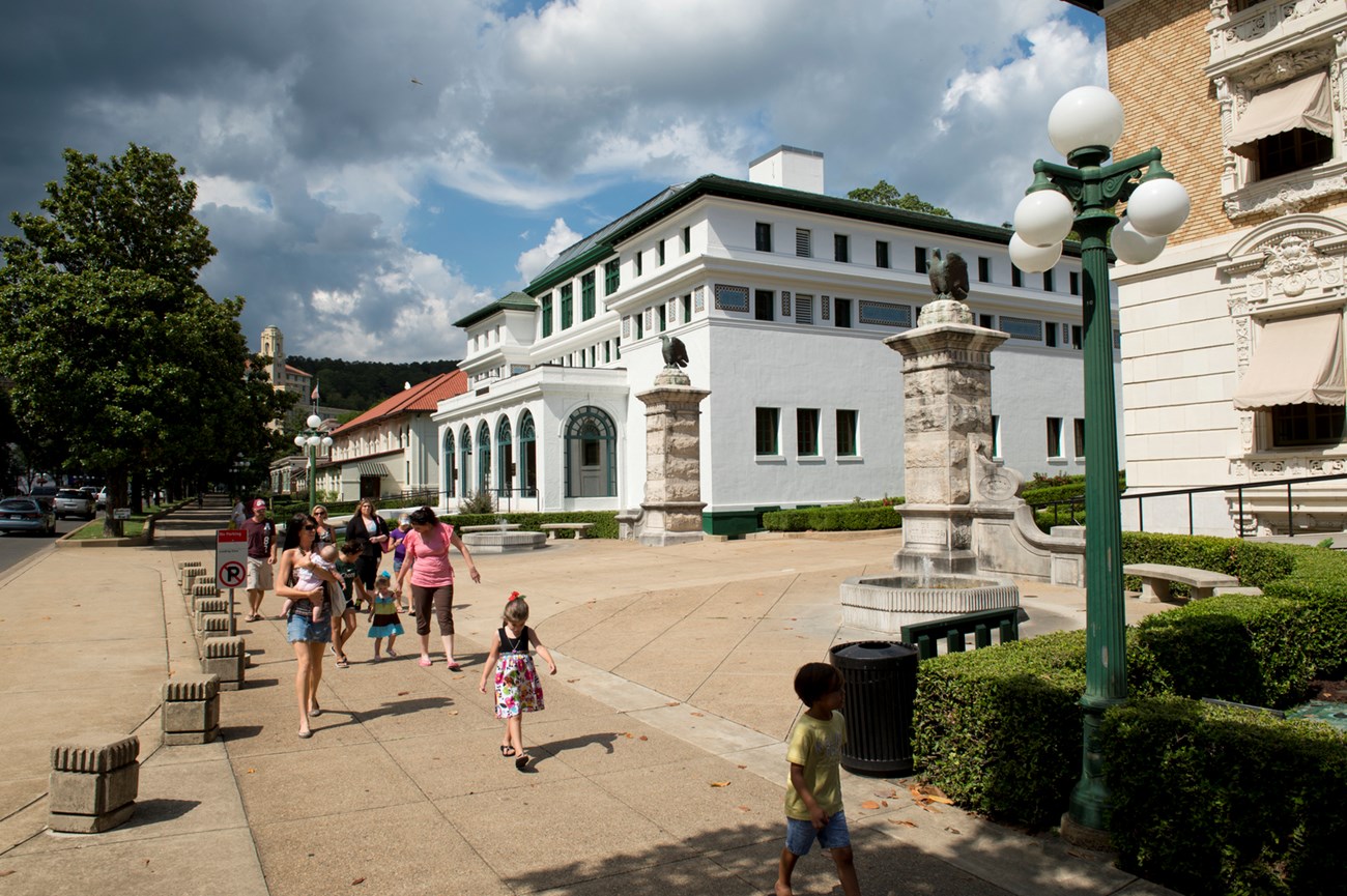 Bathhouse Row People walking on the sidewalk next to historic buildings