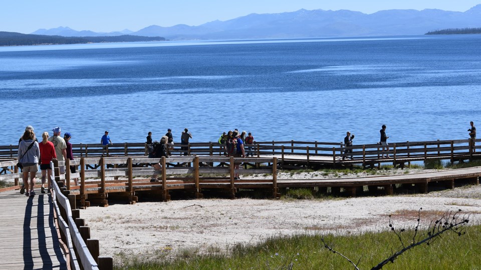 People walking along West Thumb Geyser Basin boardwalk