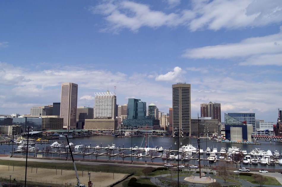 Photograph of Baltimore with water and boats in foreground and buildings in background. Photograph of Baltimore with water and boats in foreground and buildings in background.
