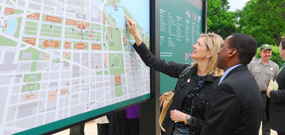 Visitors look at a map. Visitors look at a map.