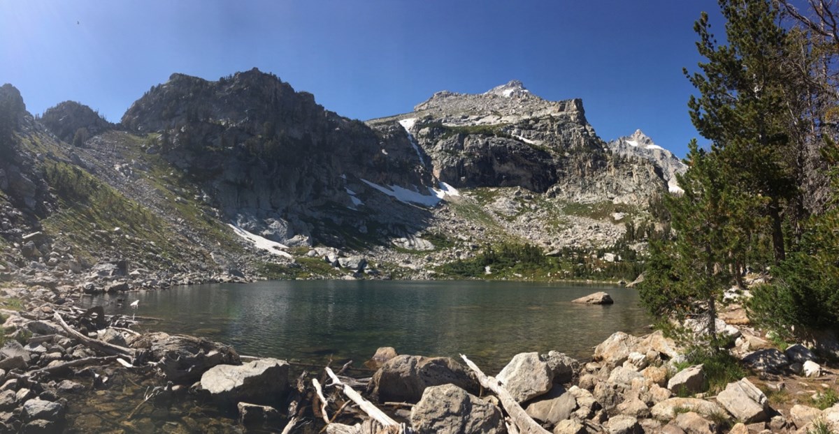 Amphitheater Lake An alpine lake sits at the base of a rocky cliff.