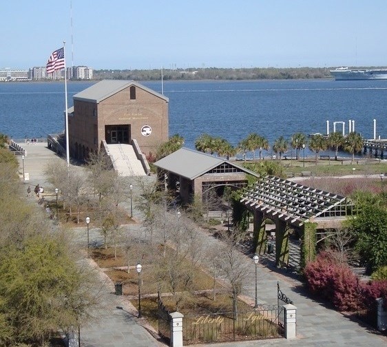 Photograph of the Fort Sumter Visitor Center at Liberty Square, the primary departure point for the boat ride to Fort Sumter. Visitor Center in the foreground with harbor in the background. Photograph of the Fort Sumter Visitor Center at Liberty Square, the primary departure point for the boat ride to Fort Sumter. Visitor Center in the foreground with harbor in the background.