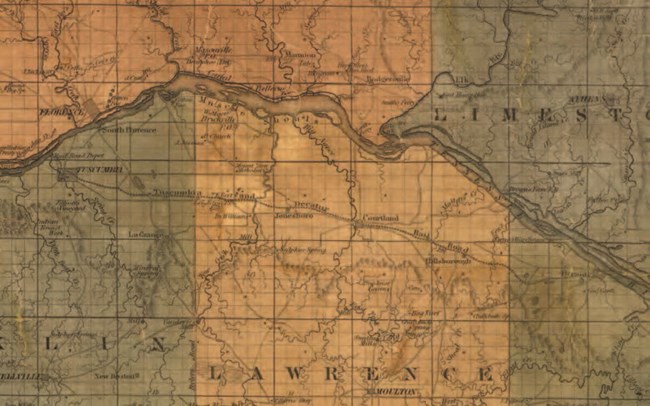 A historic map, depicting three railroad lines running through a landscape.