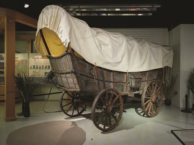 A large wooden covered wagon.