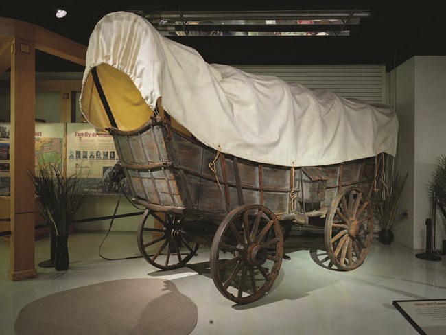 lt= A large wooden covered wagon.