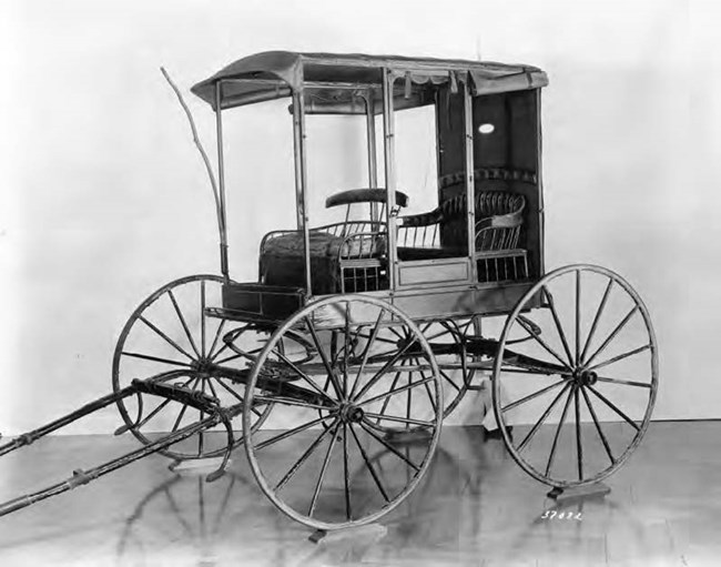 lt= A wooden wagon that is pulled by hand.