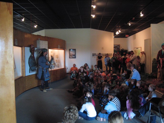 children seated and Indian performing in museum children seated and Indian performing in museum