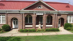colored photo of the front of the George Washington Carver Museum taken during the day
