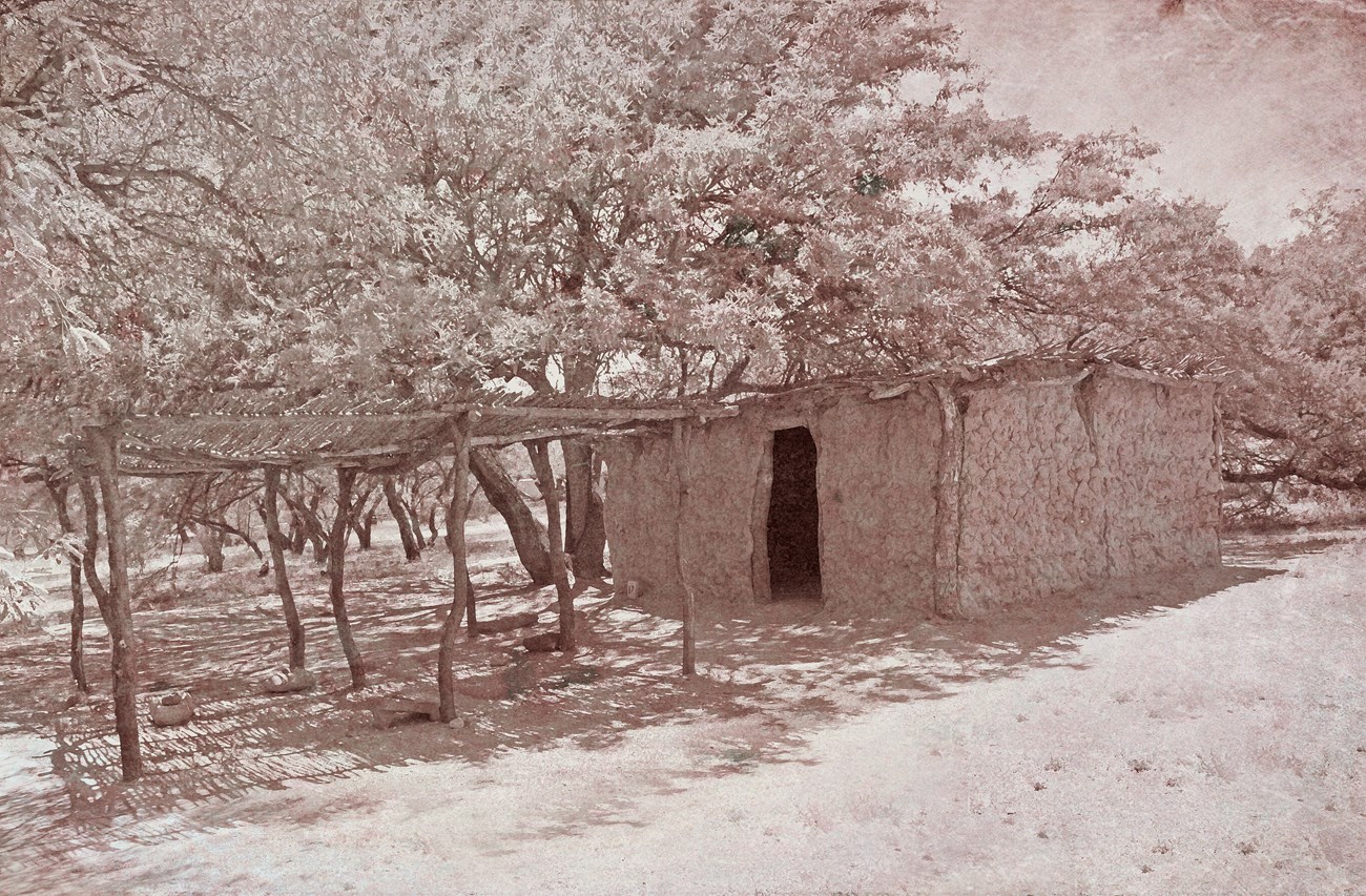 Sepia tone image of mud house.