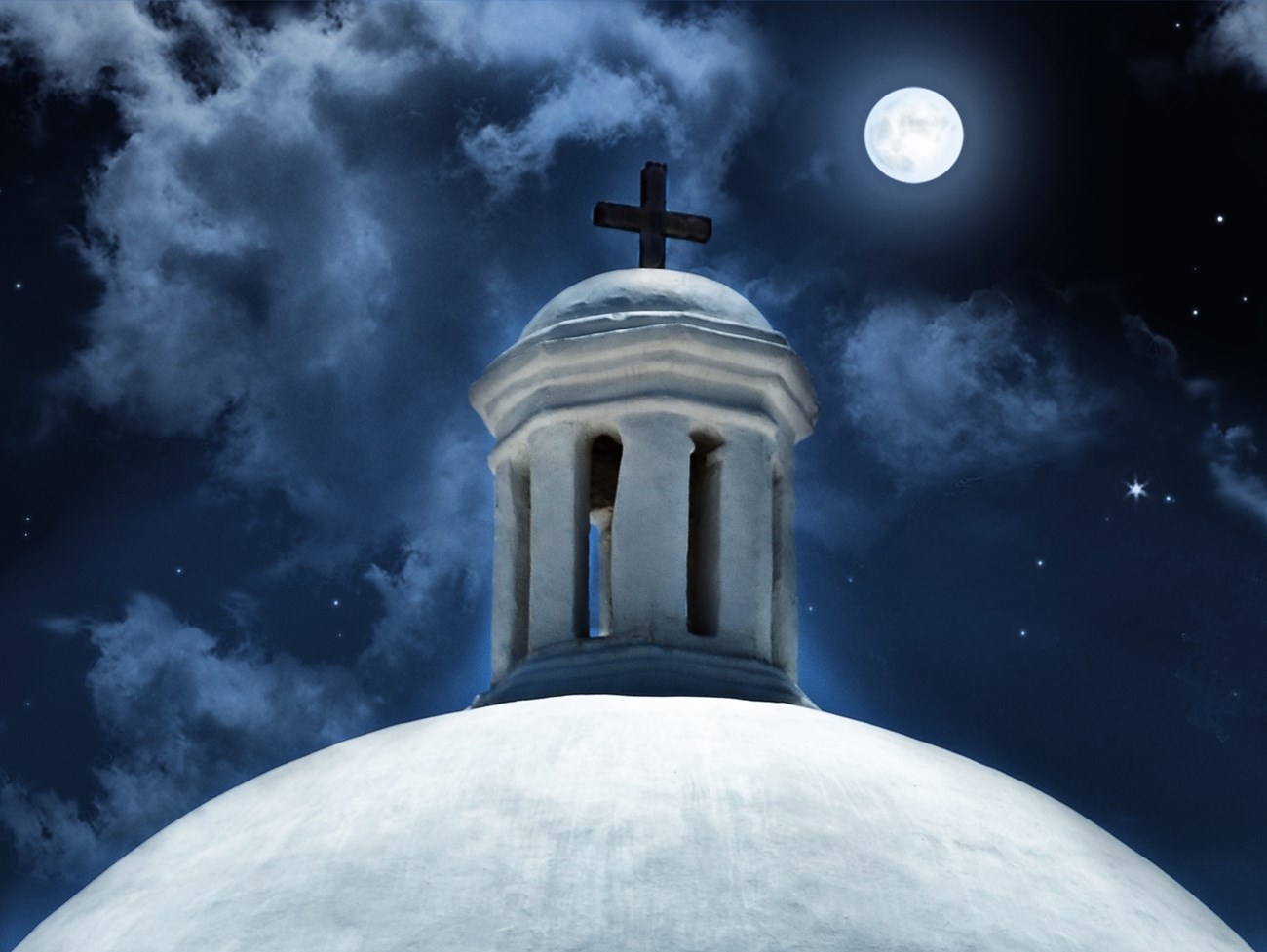 A white dome with cloudy night sky in the background.