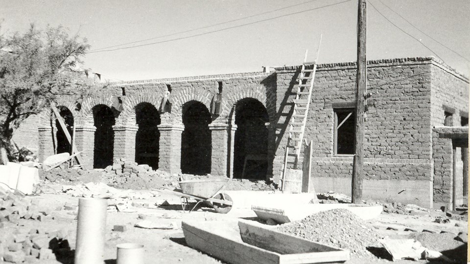 adobe museum structure with arched arcade in process of construction
