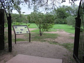 metal gate leading to orchard