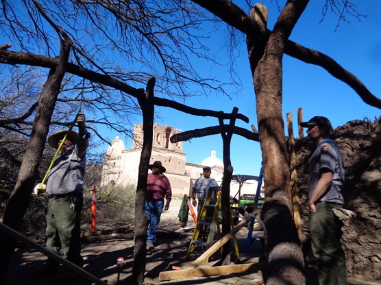 preservationists inside frame of earthen structure