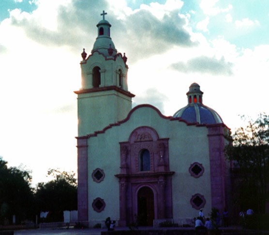 color photo of modern church with bell tower on left