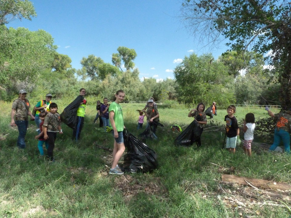 kids in forest cleaning up litter